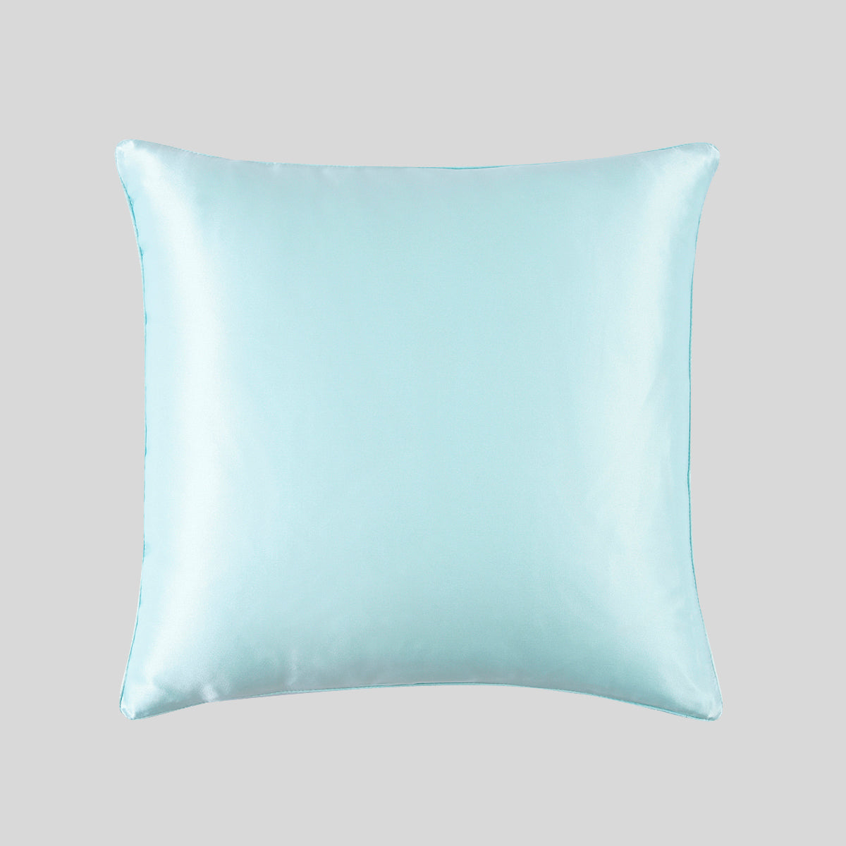 A light blue mulberry silk pillowcase on a plain studio backdrop, showcasing its smooth, reflective surface.